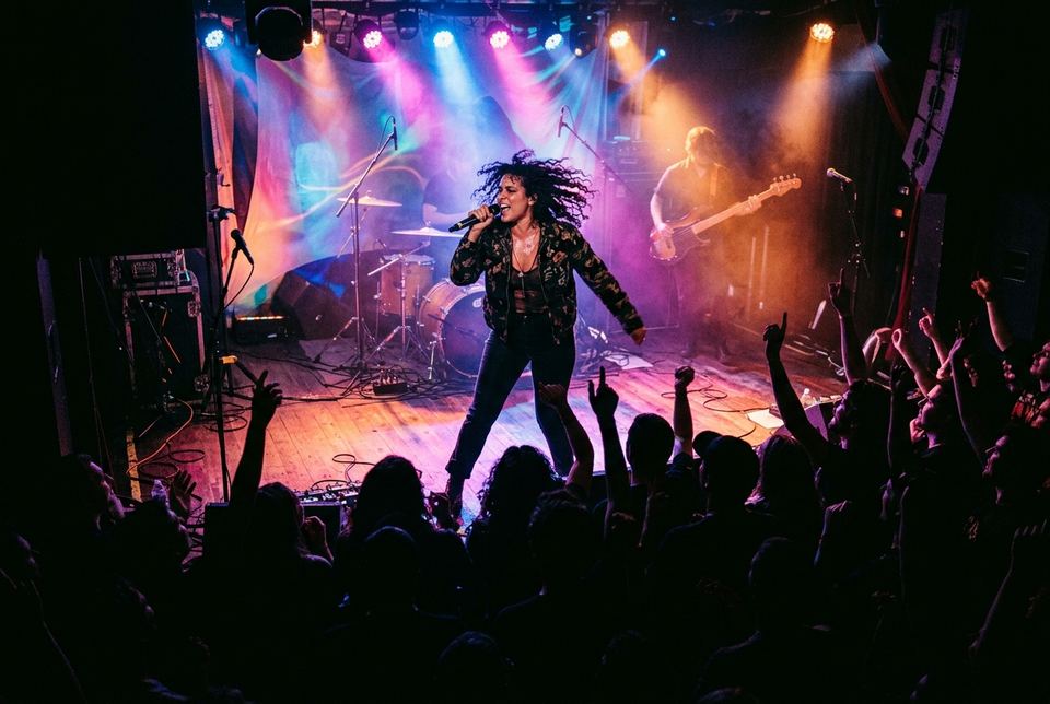 Live performer on stage with concert lighting